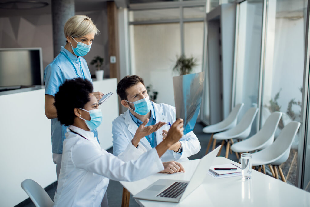 Healthcare professionals accessing patient records on a tablet